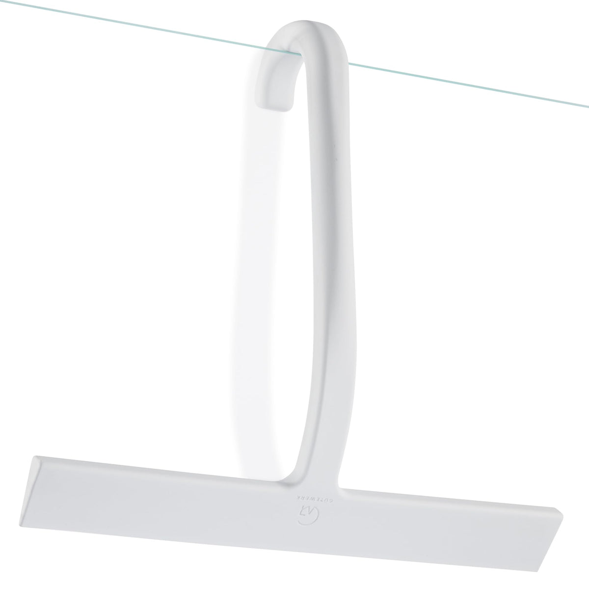 White J-hook squeegee hanging from the edge of a glass shower panel